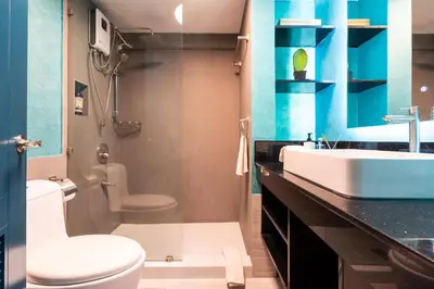 a bathroom with a toilet and a sink at Boutique one-bedroom apartment near airport, business hubs in Manila