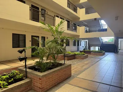 a lobby of a building with plants in pots at Boutique one-bedroom apartment near airport, business hubs in Manila
