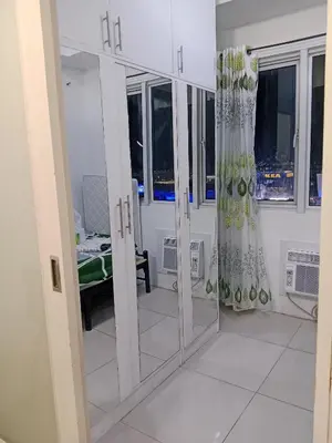 a white room with glass doors and a window at Sea Residence Tower A by Stave in Manila