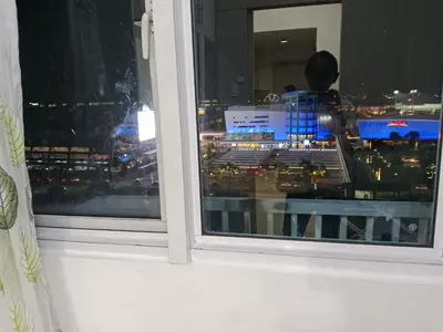 a person looking out of a window at a city at Sea Residence Tower A by Stave in Manila