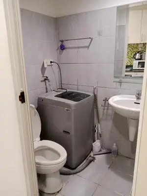 a bathroom with a toilet and a sink at Sea Residence Tower A by Stave in Manila