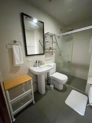 a bathroom with a sink and a toilet and a shower at 1 BR Condo in Manila near US Embassy & St Lukes in Manila