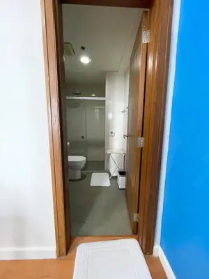 a bathroom with a toilet and a door open at 1 BR Condo in Manila near US Embassy & St Lukes in Manila