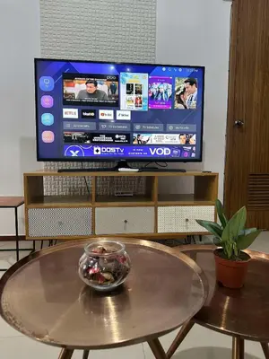 a bowl of food on a table in front of a television at Circulo verde in Manila