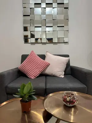 a living room with a couch and a table at Circulo verde in Manila
