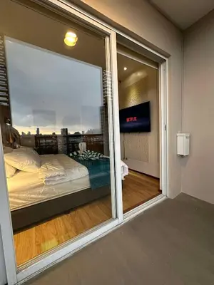 a bedroom with a view of a bed through a window at Circulo verde in Manila