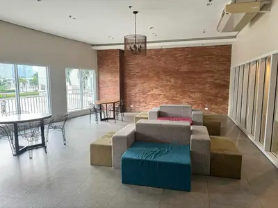 a living room with a couch and tables and a brick wall at Circulo verde in Manila