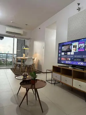 a living room with a large flat screen tv at Circulo verde in Manila