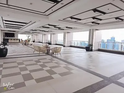 a large room with a checkered floor and windows at Vtan Condo in Manila