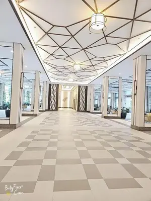 an empty lobby of a building with a checkered floor at Vtan Condo in Manila