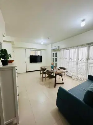 a living room with a couch and a table at Vtan Condo in Manila