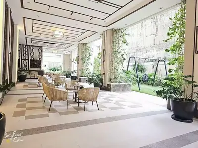 a lobby with chairs and tables in a building at Vtan Condo in Manila