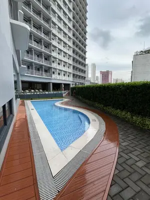 a swimming pool on the side of a building at Lush Residence in Manila