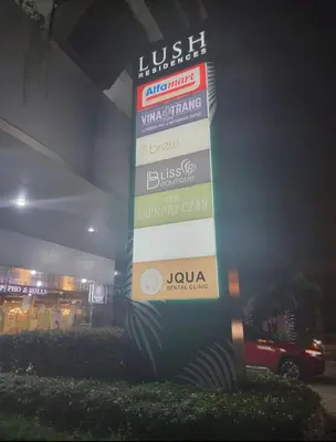 a sign in front of a store at night at Lush Residence in Manila