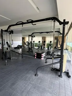 a gym with a large mirror and some tread machines at Lush Residence in Manila