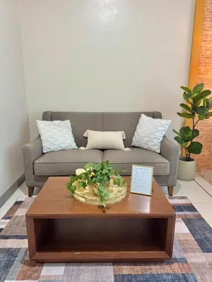 a living room with a couch and a coffee table at Chic 1-BR at Uptown BGC in Manila