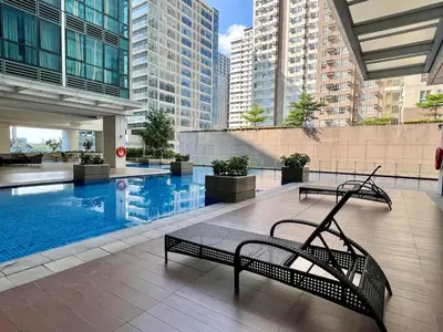 a swimming pool with a bench in a building at Chic 1-BR at Uptown BGC in Manila