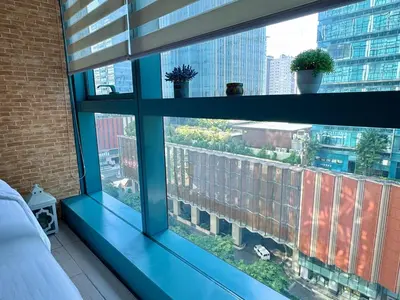 a blue window sill with a view of a city at Chic 1-BR at Uptown BGC in Manila