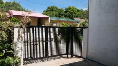 a black gate in front of a house at Santa Cosy Villa suite-B Fast Wi-Fi, Netflix Included Split system Air-con & Hot Shower Close to Enchanted Kingdom in Santa Rosa