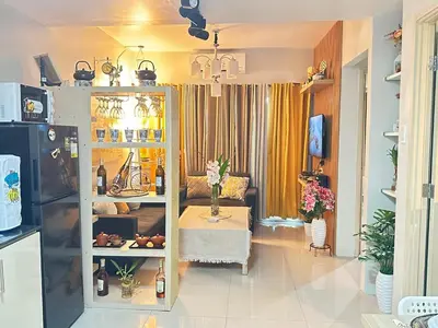 a living room with a couch and a table at A & M SUITE VACAY - Sea Residences Mall Of Asia Pasay in Manila