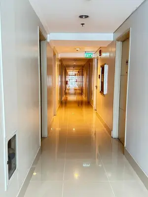 a hallway of a building with a long corridor at A & M SUITE VACAY - Sea Residences Mall Of Asia Pasay in Manila