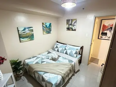 a bedroom with a bed in a room at A & M SUITE VACAY - Sea Residences Mall Of Asia Pasay in Manila