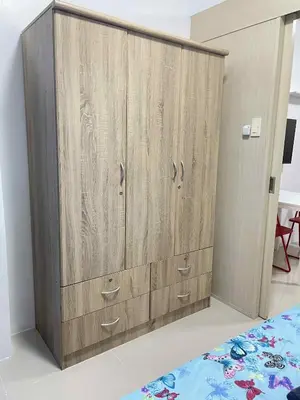 a large wooden cabinet in a bedroom with a bed at Vonz Staycation Near Moa in Manila