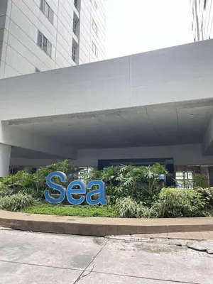 a sea sign in front of a building at Vonz Staycation Near Moa in Manila