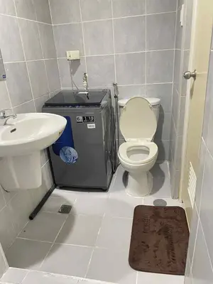 a small bathroom with a toilet and a sink at Vonz Staycation Near Moa in Manila