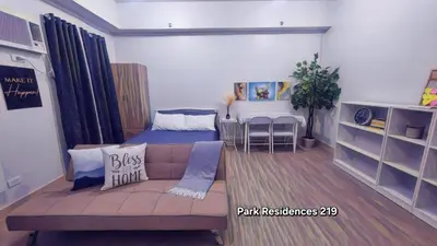 a living room with a couch and a bed at PARK RESIDENCE Unit 219, SM City Santa Rosa, Laguna, by SMDC in Ibaba
