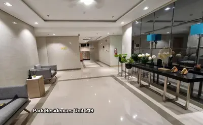 a lobby with a waiting area with couches and flowers at PARK RESIDENCE Unit 219, SM City Santa Rosa, Laguna, by SMDC in Ibaba