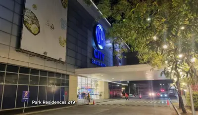 a building with a blue sign on the side of it at PARK RESIDENCE Unit 219, SM City Santa Rosa, Laguna, by SMDC in Ibaba