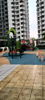 a playground with benches and a park with buildings at Cozy Gutz Place at 16th in Manila