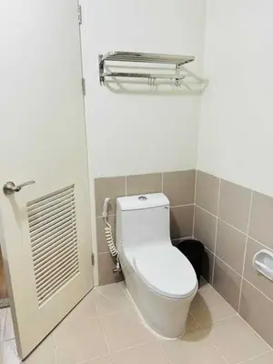 a bathroom with a toilet and a sink at Vtan Condo in Manila