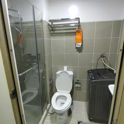 a bathroom with a shower and a toilet and a sink at Cityscape staycation in Manila