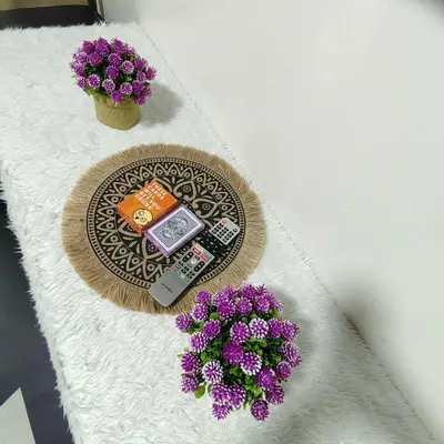 a table with two purple flowers and a cell phone at Cityscape staycation in Manila