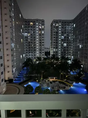a view of a city at night with tall buildings at Cityscape staycation in Manila