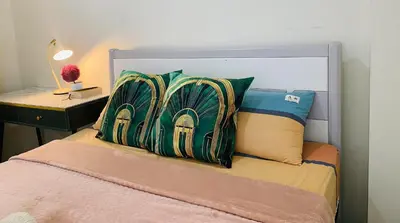 a bed with two pillows on top of it at Stan Condo in Manila