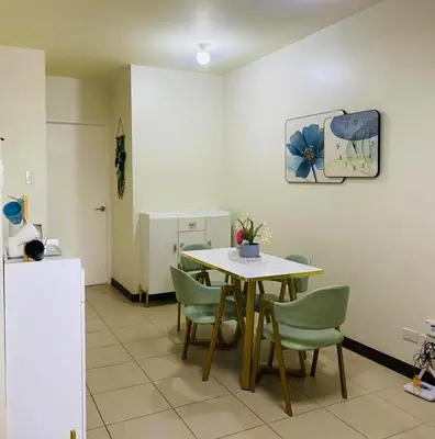 a dining room with a table and chairs at Stan Condo in Manila