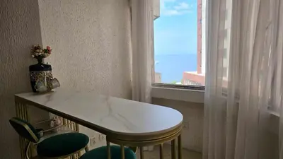 a table and chairs in a room with a window at Stan Condo in Manila