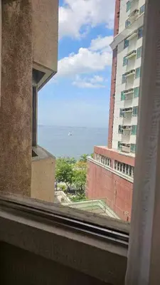a view of the ocean from a window of a building at Stan Condo in Manila