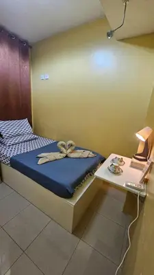 a bedroom with a bed with a bow on it at Stan Condo in Manila