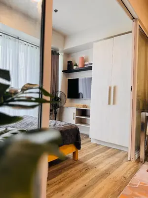a bedroom with a bed and a sliding door at Azure Urban Resort Residences in Manila