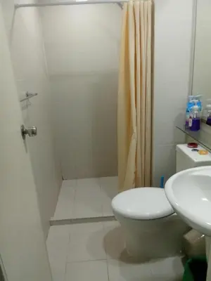 a bathroom with a shower and a toilet and a sink at Azure Urban Resort Residences in Manila