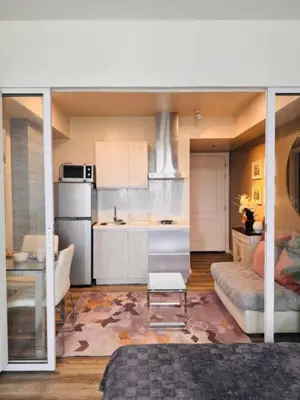 a kitchen with a couch and a table in a room at Azure Urban Resort Residences in Manila