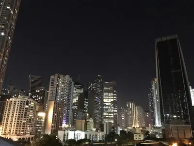 a city skyline at night with tall buildings at Cosy Studio with balcony 100mbps and Netflix in Manila