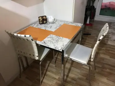 a dining room table with two chairs and a table with a counter at Cosy Studio with balcony 100mbps and Netflix in Manila