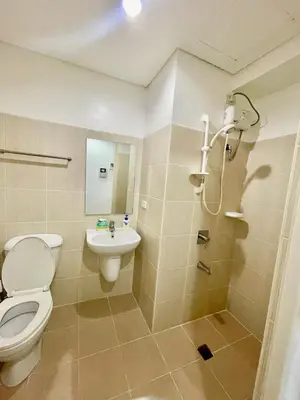 a bathroom with a toilet and a sink and a shower at Studio Unit at Grand Riviera Suites in front of US Embassy in Manila