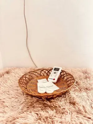 a remote control sitting on top of a wicker basket at Cozy and comfy place at Ortigas Pasig City in Manila