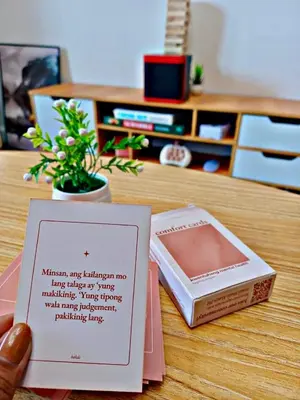 a table with a card and a box on it at Cozy and comfy place at Ortigas Pasig City in Manila